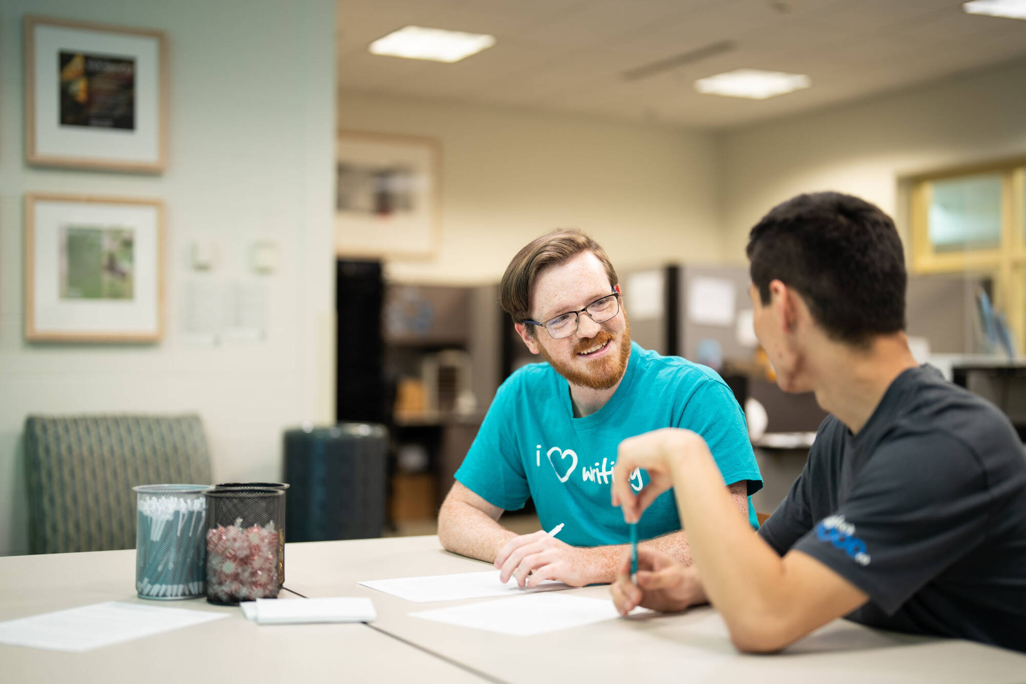 Student and Consultant working together at a table in the writing center
